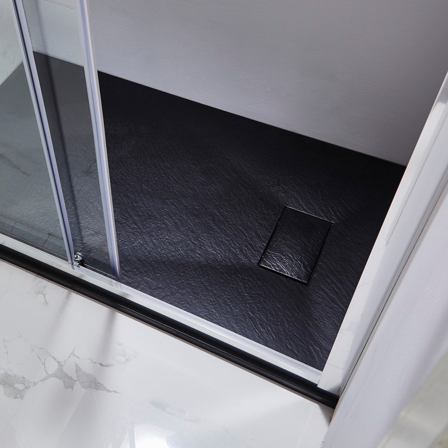 Black SMC shower tray with a square drain in a modern bathroom setting